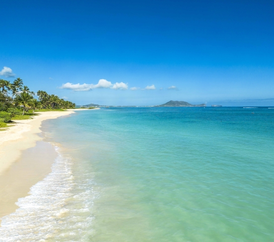Horizon view where white beach meets turquoise blue water.