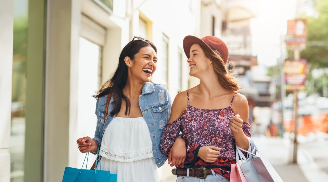 Shot of two young friends enjoying a day of shopping